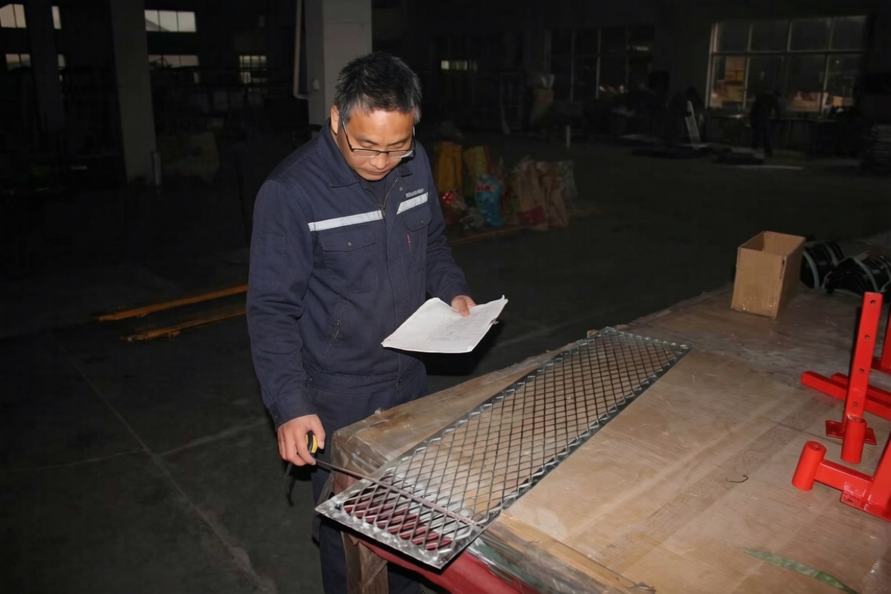QC worker checking an expanded metal mesh part against a drawing and checklist